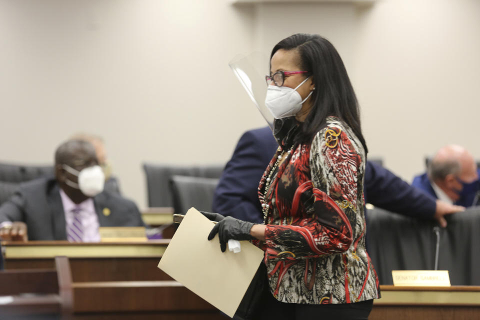 South Carolina Sen. Mia McLeod, D-Columbia, walks to her seat as the South Carolina Senate Medical Affairs meets on Thursday, Jan. 21, 2021 in Columbia, S.C. The committee approved a stricter ban on abortions. (AP Photo/Jeffrey Collins)