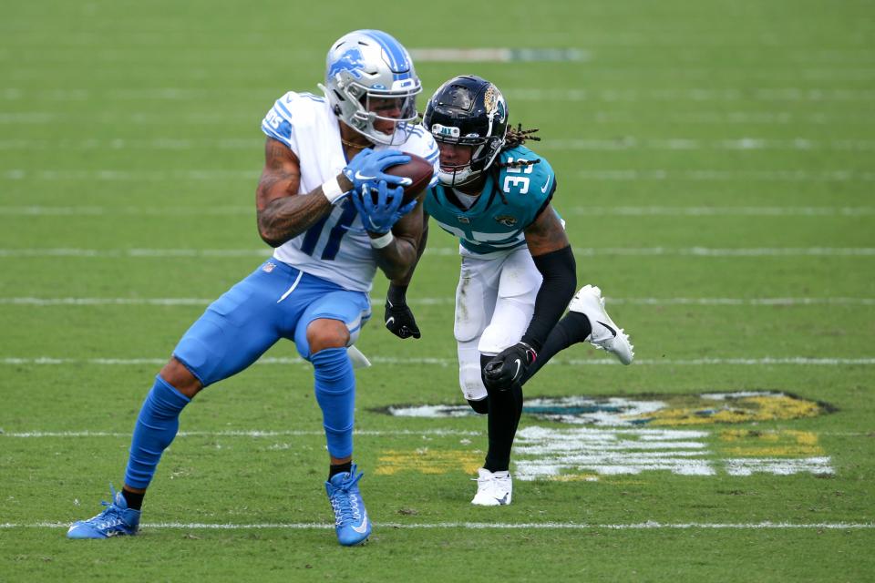 Detroit Lions wide receiver Marvin Jones Jr., left, makes a reception in front of Jacksonville Jaguars cornerback Sidney Jones (35) during the second half of an NFL football game, Sunday, Oct. 18, 2020, in Jacksonville, Fla. (AP Photo/Stephen B. Morton)