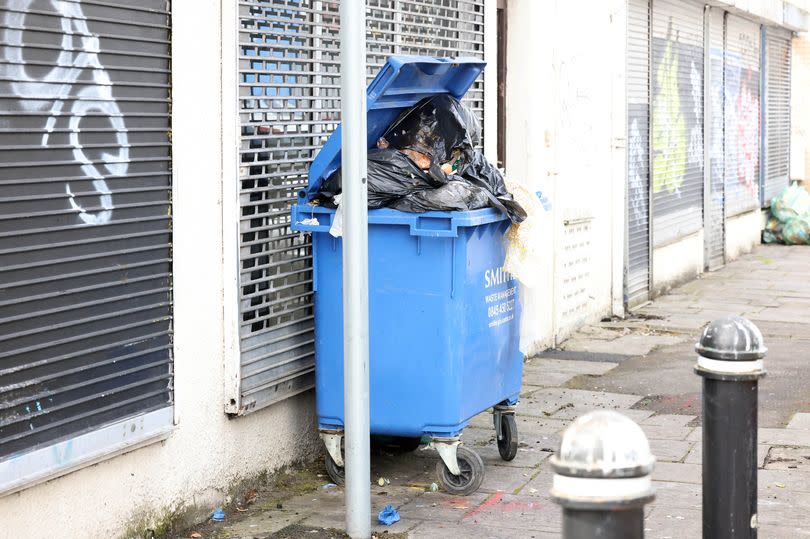 A picture of an overflowing wheelie bin on City Road
