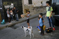 A child plays with a traffic cone in the Catia neighborhood of Caracas, Venezuela, Saturday, April 17, 2021, amid the new coronavirus pandemic. (AP Photo/Matias Delacroix)