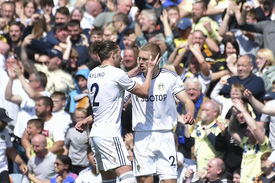 Leeds United's Rasmus Kristensen, right, is congratulated by teammate Luke Ayling after scoring his side's 2nd goal during the English Premier League soccer match between Leeds United and Newcastle United at Elland Road in Leeds, England, Saturday, May 13, 2023. (AP Photo/Rui Vieira)