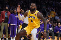 Los Angeles Lakers forward LeBron James (6) reacts after dunking during the second half of an NBA basketball game against the Boston Celtics Tuesday, Dec. 7, 2021, in Los Angeles. (AP Photo/Marcio Jose Sanchez)