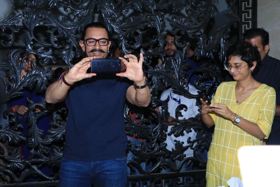 Aamir and Kiran take pictures of the celebration.