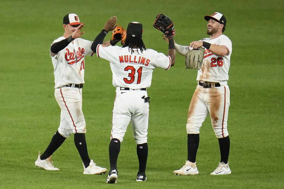 Baltimore Orioles center fielder Cedric Mullins (31) celebrates with outfielders Austin Hays, left, and Ryan McKenna after a baseball game against the Chicago White Sox, Tuesday, Aug. 29, 2023, in Baltimore. The Orioles won 9-3. (AP Photo/Julio Cortez)