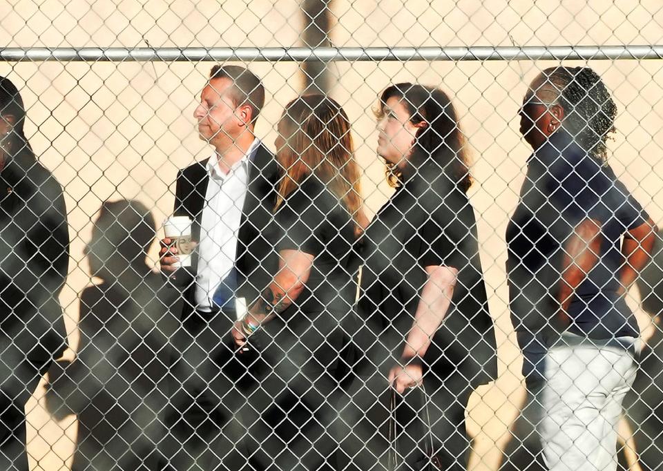 U.S. Congressmen Rep. Jared Moskowitz, left, waits with others to tour Marjory Stoneman Douglas High School, Aug. 4, 2023, in Parkland, Fla.