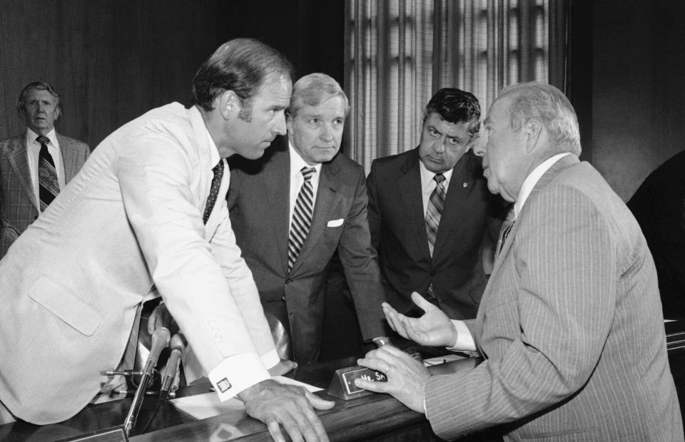 FILE - In this July 13, 1982, file photo Secretary of State designate George Shultz, right, speaks with members of the Senate Foreign Relations Committee prior to the start of the afternoon session of the panel on Capitol Hill in Washington. From left. Sen. Joseph Biden, D-Del.; Sen. Charles Percy, R-Ill., chairman of the panel and Sen. Edward Zorinsky, D-Neb. (AP Photo/Ira Schwarz, File)