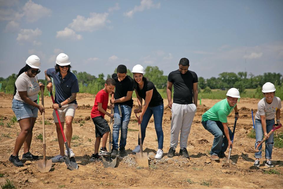 Amanda, fifth from left, who was selected to receive a Show-Me Central Habitat for Humanity home, helps break ground in June for her residence at the Boone Prairie Subdivision. She is joined by her children and representatives of Veterans United and Show-Me Habitat. Her home is sponsored by Veterans United Foundation and will be part of the Blitz Build from Show-Me Habitat starting next week.
