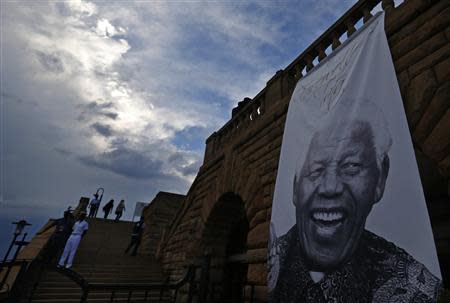 A giant picture of former South African President Nelson Mandela is pictured at the entrance of the Union Buildings in Pretoria December 12, 2013. REUTERS/Yves Herman