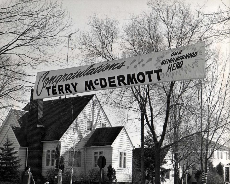 Banners back home in Michigan congratulate Terry McDermott for his 1964 Winter Olympics victory.