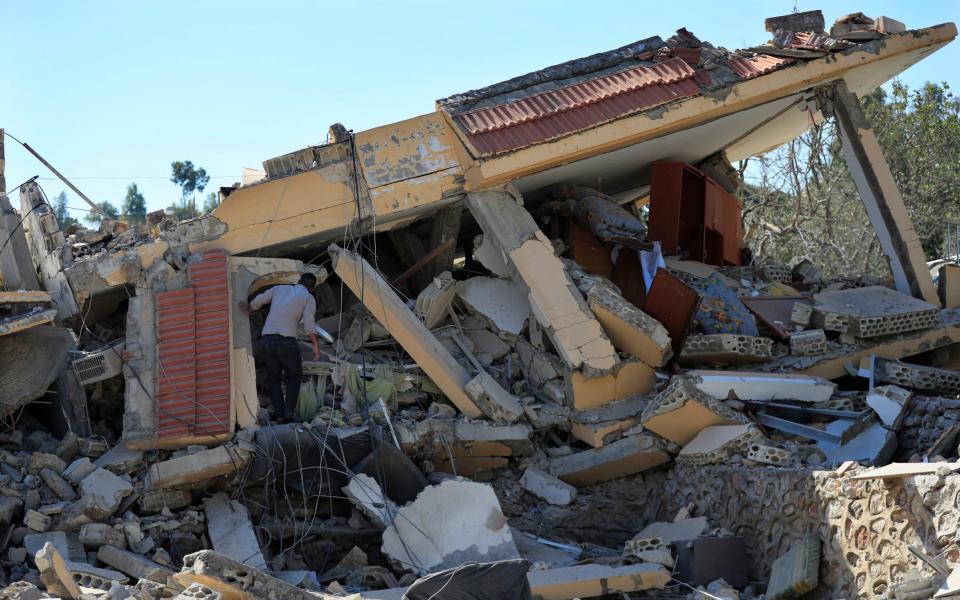 A Lebanese man checks a destroyed house that was hit by an Israeli airstrike in southern Lebanon. Hezbollah and Israel have been exchanging fire since a day after the Israel-Hamas war began on Oct 7