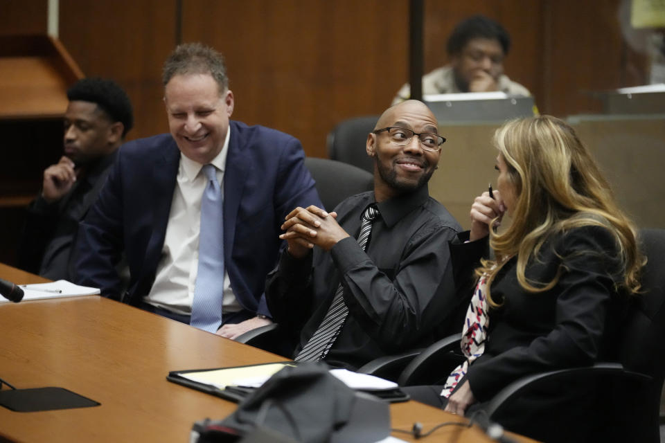 Juan Rayford, second from right, and Dupree Glass, far left, sit with their attorneys Eric Dubin, second from left, and Annee Della Donna, right, during a hearing on their case at the Clara Shortridge Foltz Criminal Justice Center Thursday, April 20, 2023, in Los Angeles. Rayford and Glass were convicted of attempted murder and sentenced to 11 consecutive life sentences. They served 17 years in prison before being released in 2020 after a judge ruled they were wrongfully convicted. (AP Photo/Marcio Jose Sanchez)