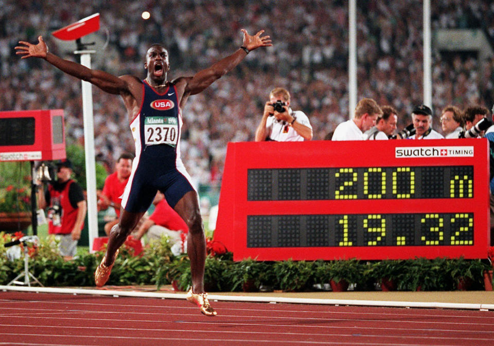 FILE - Michael Johnson, of the United States, celebrates after he won the men's 200-meter final in a world record time of 19.32 at the 1996 Summer Olympic Games in Atlanta, Aug. 1, 1996. Sprinting great Michael Johnson is launching a track league that looks to assemble nearly 100 of the sport's top performers four times a year to compete for $12.6 million in prize money over its first season. The league, Grand Slam Track, announced Tuesday, June 18, 2024, that it will launch next April with plans for one event in Los Angeles, the home of the 2028 Olympics, one in another American city and two more overseas. (AP Photo/Doug Mills, File)
