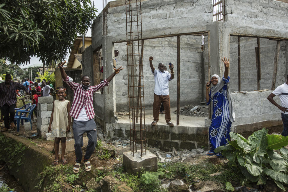 Supporters of Guinean opposition leader Cellou Dalein Diallo cheer at his headquarters in Conakry, Guinea, Monday Oct. 19, 2020. Diallo declared himself the winner after the country held an election on Sunday with Guinean President Alpha Conde seeking to extend his decade in power. (AP Photo/Sadak Souici)