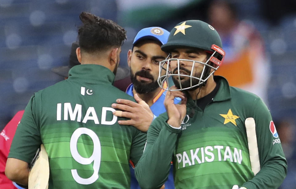 India's captain Virat Kohli, center, greets Pakistan players at the end of the Cricket World Cup match between India and Pakistan at Old Trafford in Manchester, England, Sunday, June 16, 2019. (AP Photo/Aijaz Rahi)