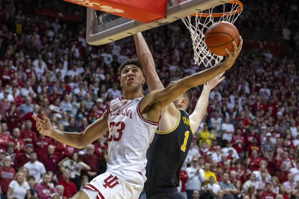 FILE - Indiana forward Trayce Jackson-Davis (23) shoots around the defense of Michigan center Hunter Dickinson (1) during the second half of an NCAA college basketball game, Sunday, March 5, 2023, in Bloomington, Ind. Jackson-Davis was selected to The Associated Press All-Big Ten team in voting released Tuesday, March 7, 2023. (AP Photo/Doug McSchooler, File)