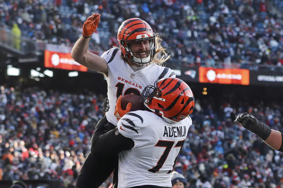 Cincinnati Bengals wide receiver Trenton Irwin, top, celebrates his touchdown with Cincinnati Bengals guard Hakeem Adeniji (77) during the first half of an NFL football game against the New England Patriots, Saturday, Dec. 24, 2022, in Foxborough, Mass. (AP Photo/Michael Dwyer)