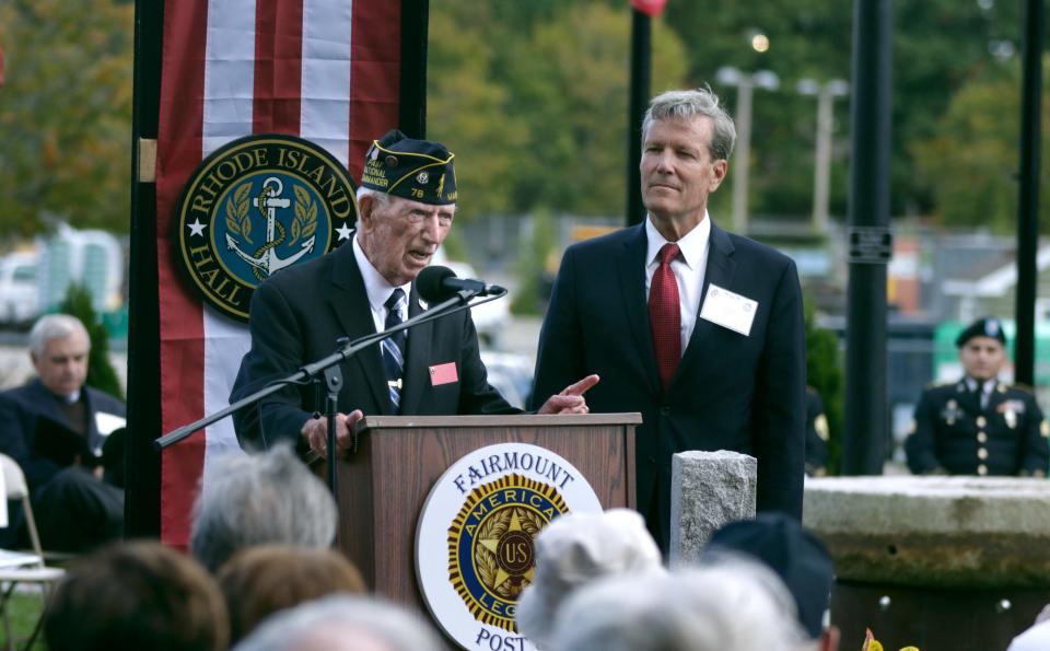 Jake Comer, past national commander of the American Legion, speaks at the dedication of the World War II Memorial Park on Oct. 17, 2021 in Woonsocket. Event emcee Steve Aveson, right, listens from the side.