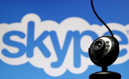 A web camera is seen in front of a Skype logo in this photo illustration taken in Zenica, May 26, 2015. REUTERS/Dado Ruvic