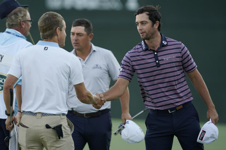 Davis Riley, right, shakes hands with Peter Malnati after they finished the first round of the Sanderson Farms Championship golf tournament in Jackson, Miss., Thursday, Sept. 29, 2022. (AP Photo/Rogelio V. Solis)