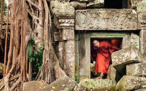 A Cambodian monk in Angkor Wat - Credit: iStock