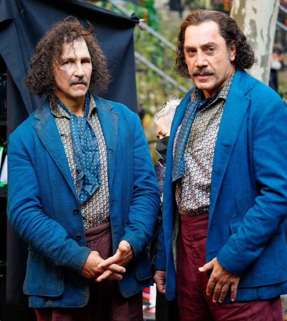 Bardem and his body guard with long hair and same-color jackets