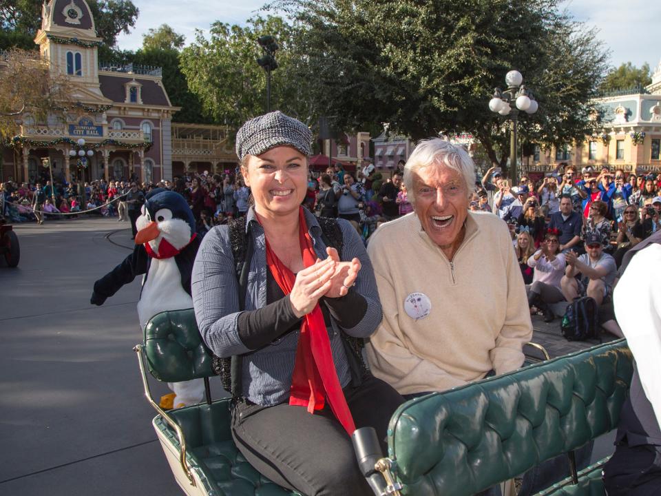 dick van dyke and arlene silver on a cart at disneyland celebrating his 90th birthday