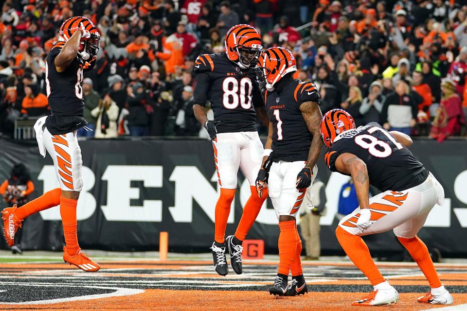Cincinnati Bengals wide receiver Ja'Marr Chase (1), center, is congratulated by Mike Thomas (80) after catching a touchdown pass this season against the San Francisco 49ers.