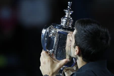 Sep 9, 2018; New York, NY, USA; Novak Djokovic of Serbia kisses the championship trophy after his match against Juan Mart’n Del Potro of Argentina (not pictured) in the men's final on day fourteen of the 2018 U.S. Open tennis tournament at USTA Billie Jean King National Tennis Center. Mandatory Credit: Geoff Burke-USA TODAY Sports
