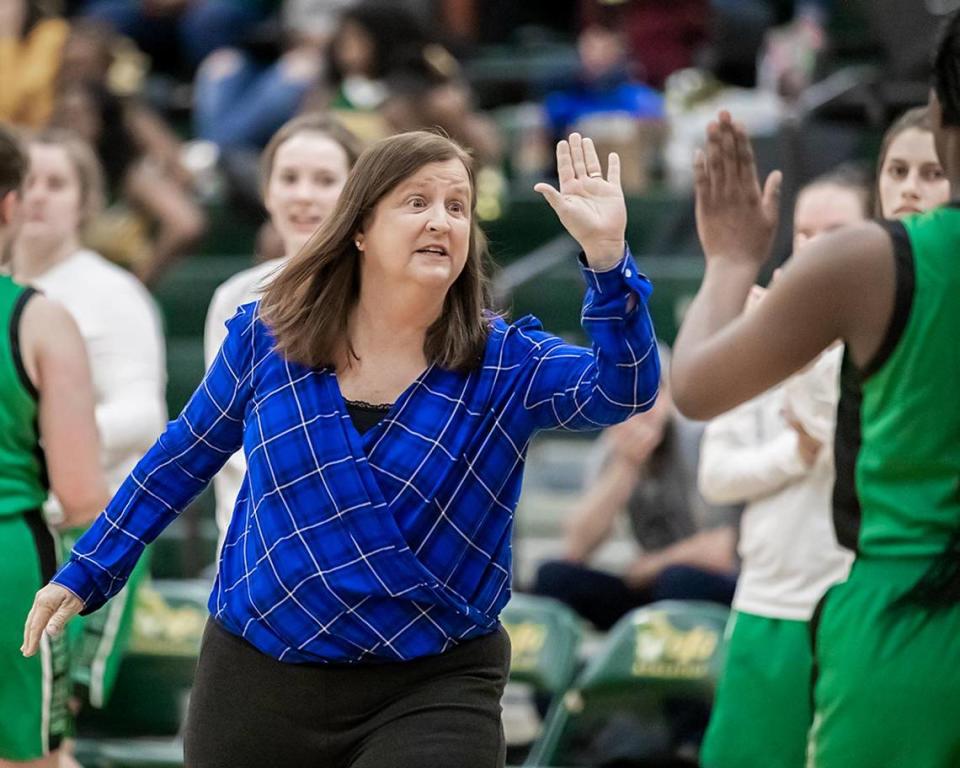 Myers Park Head Coach Barbara Nelson gathers her team for an early 1st quarter Patriot timeout. Jonathan Aguallo/Special to the Observer