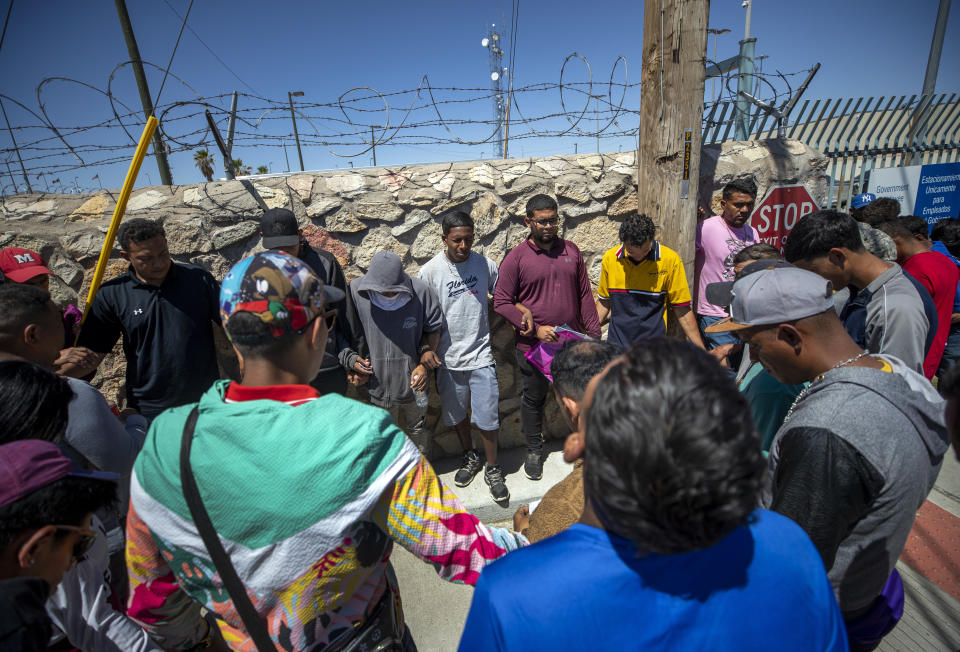 FILE - Migrants pray before turning themselves in to immigration authorities in downtown El Paso, Texas on Tuesday, May 9, 2023. (AP Photo/Andres Leighton, File)