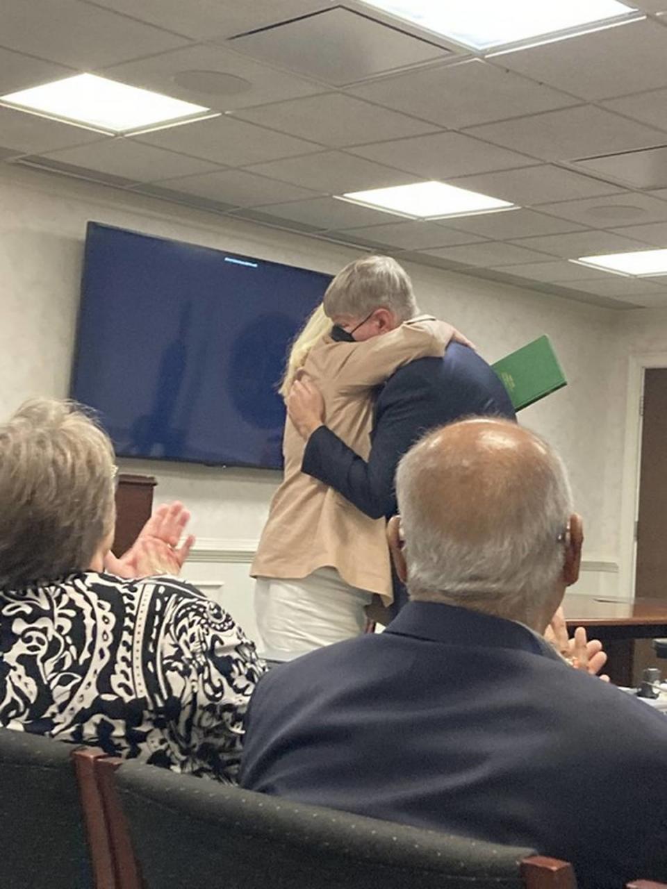 Incoming Department of Environmental Services director Myra Reece hugs new Department of Public Health director Edward Simmer during the final meeting of the S.C. Department of Health and Environmental Control board. Both Simmer and Reece work for DHEC, but will take charge of the new agencies that will replace DHEC July 1, 2024.