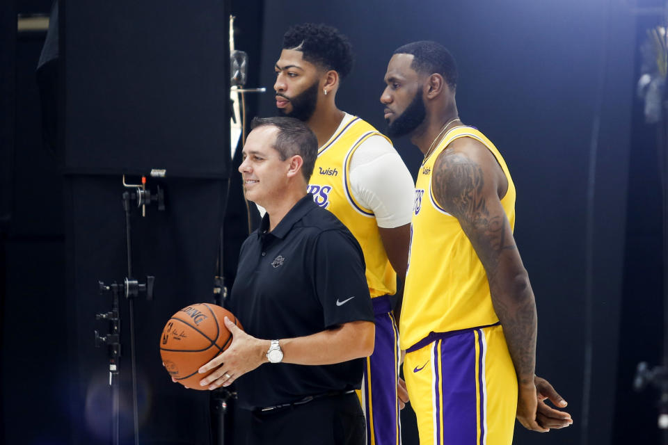 Los Angeles Lakers head coach Frank Vogel, left, forwards LeBron James, right, and Anthony Davis pose for photos during the NBA basketball team's media day in El Segundo, Calif., Friday, Sept. 27, 2019. (AP Photo/Ringo H.W. Chiu)