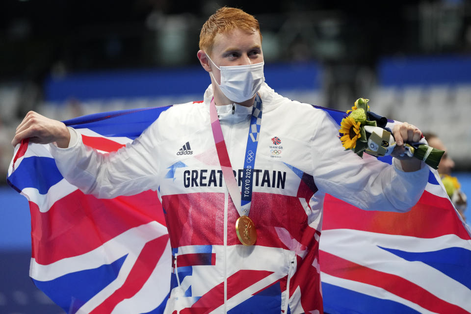 Tom Dean of Britain celebrates after winning the gold medal in the men's 200-meter freestyle at the 2020 Summer Olympics, Tuesday, July 27, 2021, in Tokyo, Japan. (AP Photo/Matthias Schrader)