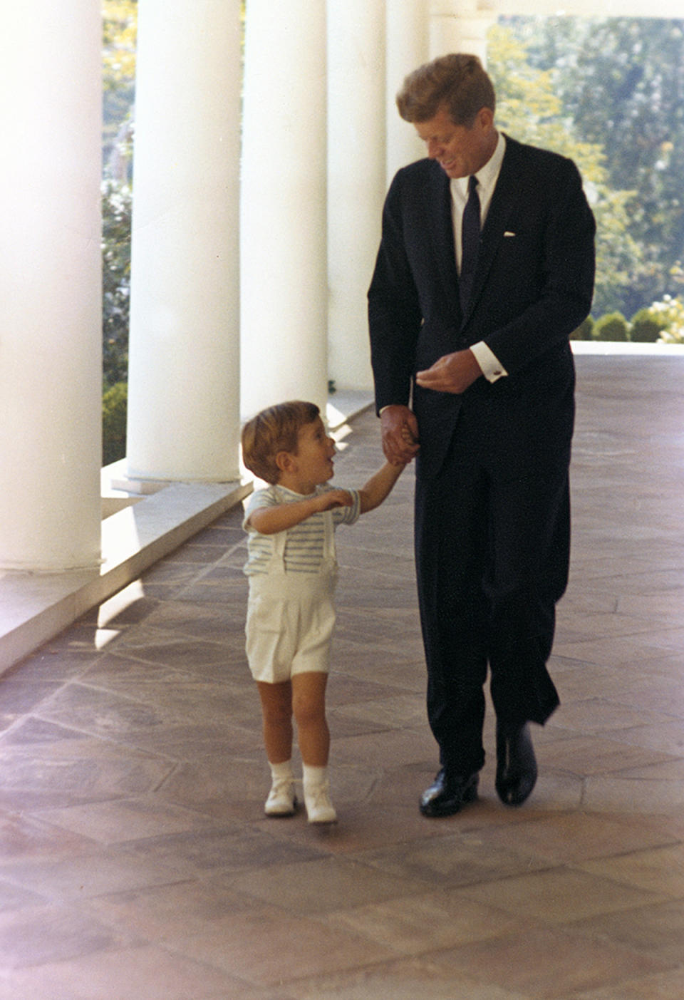 <p>President John F. Kennedy walks with son John F. Kennedy Jr. down the White House’s West Wing colonnade in Washington, Oct. 10, 1963. (Photo: Cecil Stoughton/White House/John F. Kennedy Presidential Library and Museum) </p>