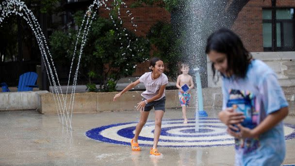 PHOTO: Kids play in a splash pad at Hemisfair Park as temperatures reached 93°F in San Antonio, Texas, June 28, 2022.  (Kaylee Greenlee Beal/Reuters)
