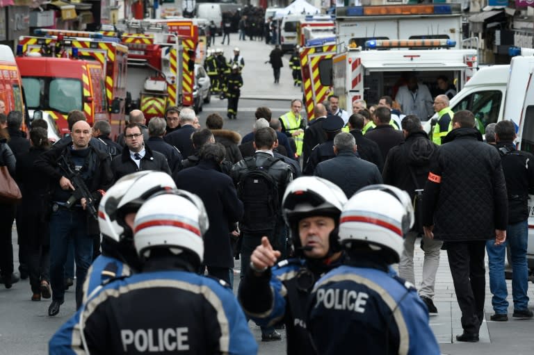 Policemen and firefighters swarm the northern Paris suburb of Saint-Denis on November 18, 2015, as the emergency services see a spike in interest from young potential recruits in the wake of the November 13 jihadist attacks on Paris