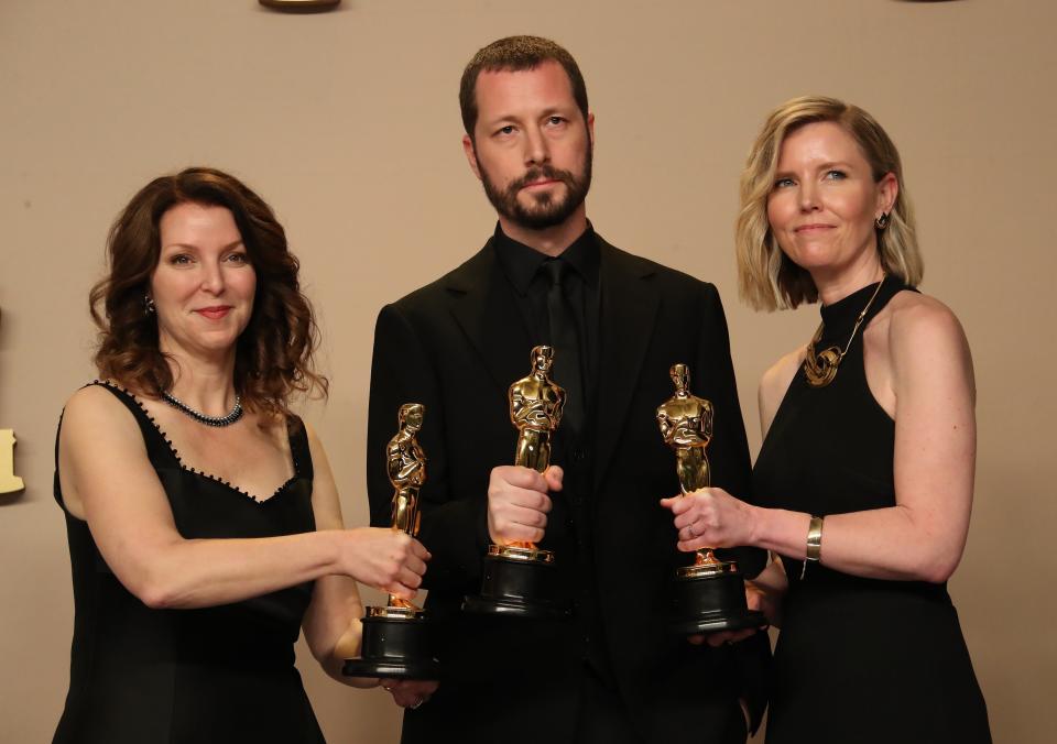 From left, Raney Aronson-Rath, Mstyslav Chernov and Michelle Mizner win the best documentary Oscar for their feature film "20 Days in Mariupol" on March 10, 2024, in Los Angeles.