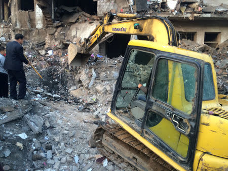 An excavator is seen at site after an explosion hit a town in Fugu county, Shaanxi province, China, October 24, 2016. China Daily/via REUTERS