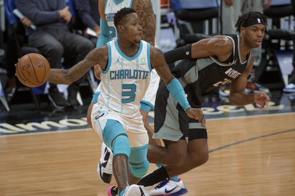 Charlotte Hornets guard Terry Rozier (3) passes the ball as Sacramento Kings guard Buddy Hield (24) defends during the second half of an NBA basketball game in Sacramento, Calif., Sunday, Feb. 28, 2021. The Hornets won 127-126. (AP Photo/Randall Benton)