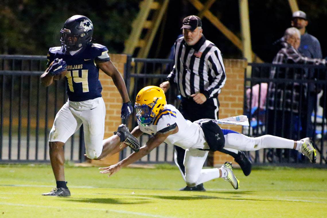 John Milledge running back Javian Butts (14) outruns a diving attempt by Tattnall’s Antone Johnson (3) for a touchdown on their first drive of the game Friday night.. Donn Kester/For The Telegraph