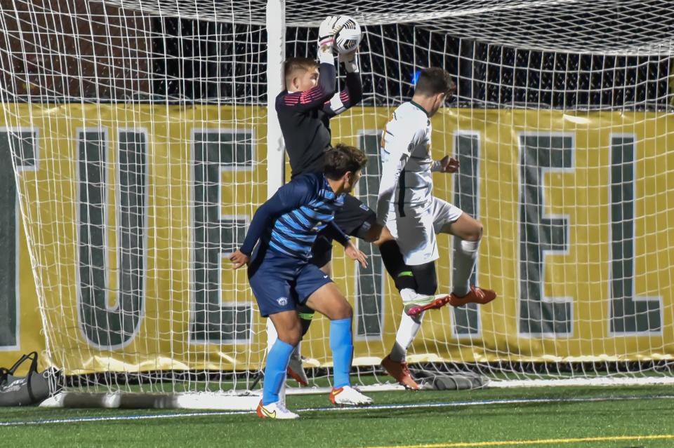 Villanova's goalie Carson Williams makes a leaping save during the first round of the NCAA Men's Soccer Tournament at UVM's Virtue Field on Thursday evening.