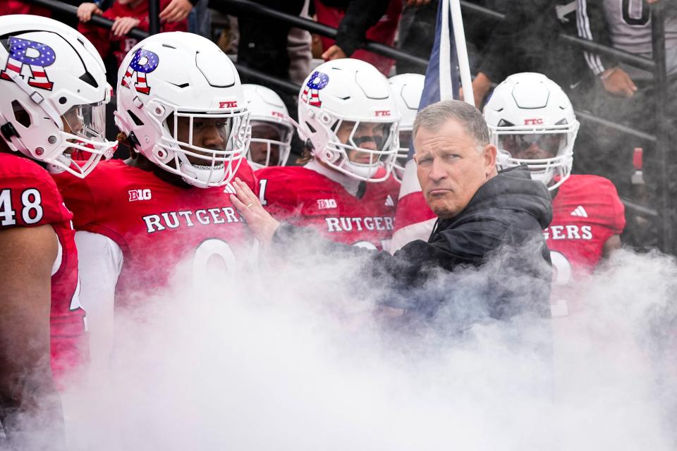 Nov 4, 2023; Piscataway, New Jersey, USA; Rutgers Scarlet Knights head coach Greg Schiano leads his team onto the field prior to the first half of the NCAA football game against the Ohio State Buckeyes at SHI Stadium.