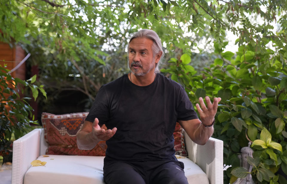 Pangea charity president Luca Lo Presti gestures during an interview with AP at his home in Milan, Italy, Thursday, Aug. 19, 2021. The Italian charity Pangea helped tens of thousands of Afghan women become self-supporting in the last 20 years. Now, dozens of its staff in Afghanistan are in hiding with their families amid reports that Taliban are going door-to-door in search of citizens who worked with Westerners. (AP Photo/Antonio Calanni)