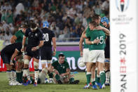 Scotland and Ireland players greet each other after the Rugby World Cup Pool A game at International Stadium between Ireland and Scotland in Yokohama, Japan, Sunday, Sept. 22, 2019. (AP Photo/Eugene Hoshiko)