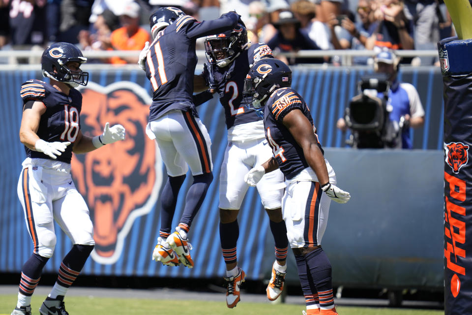 Chicago Bears wide receiver DJ Moore (2) celebrates his touchdown with wide receiver Darnell Mooney (11) during the first half of an NFL preseason football game against the Tennessee Titans, Saturday, Aug. 12, 2023, in Chicago. (AP Photo/Erin Hooley)