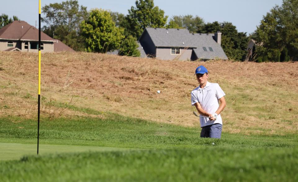 Wynford's Weston Prenger hits out of the bunker around the green of No. 8 at Stone Ridge in the Division III district tournament.