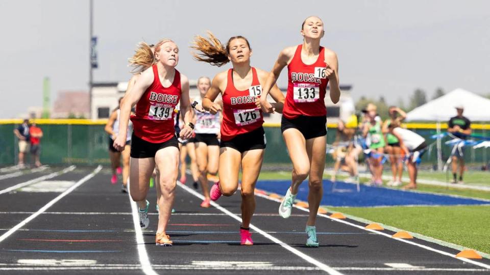 Boise runners Sammy Smith, left, Allie Bruce, center, and Lydia Nance, right, make a tight race to the finish line of the 5A girls 800 meters. Nance took first place, Smith took second, and Bruce took third.