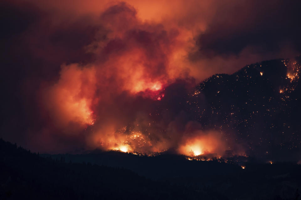 A wildfire burns on the side of a mountain in Lytton, B.C., Thursday, July 1, 2021. (Darryl Dyck/The Canadian Press via AP)