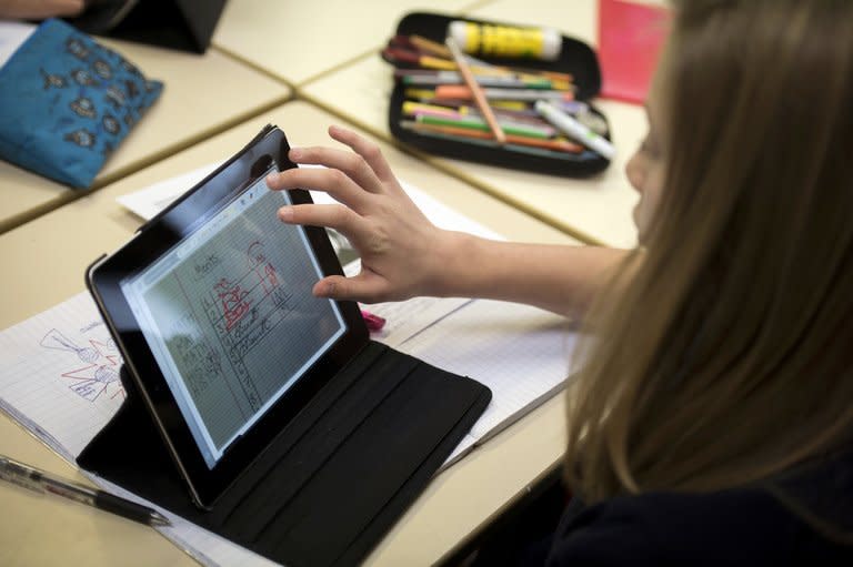 A student is seen using an iPad digital tablet at the British School of Paris, in Croissy-sur-Seine. Instead of textbooks, the pupils at the school are now pouring over tablet computers linked in to a wireless broadband network