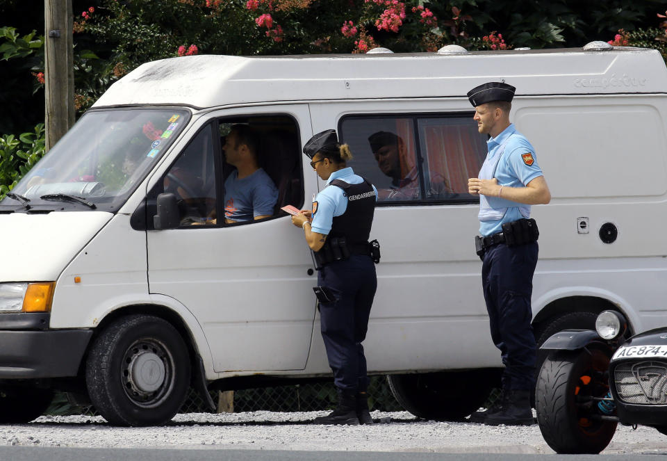 French police officers check vehicles, in Saint Pee sur Nivelle, southwestern France, Sunday, Aug. 18, 2019. ahead of the G7 summit which will take place in Biarritz on Aug. 24-26, 2019. (AP Photo/Bob Edme)